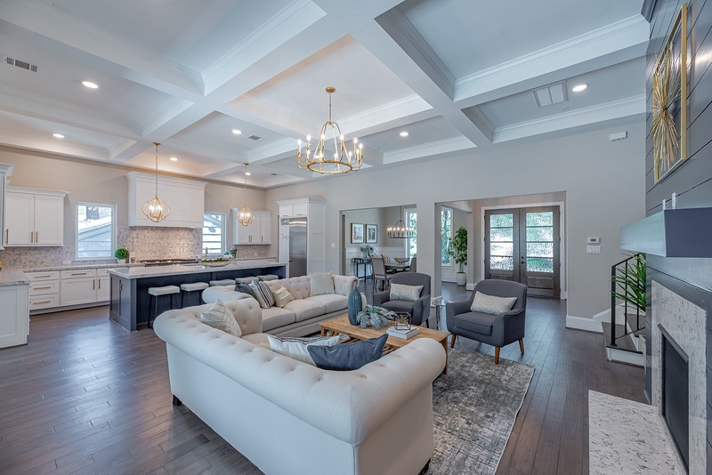 Photo of an expansive transitional open concept living room in Houston with dark hardwood floors and coffered.