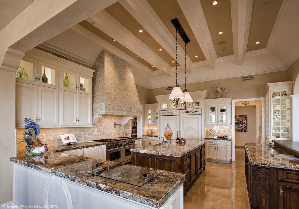 Design ideas for a traditional open plan kitchen in Phoenix with a farmhouse sink, raised-panel cabinets, granite benchtops, panelled appliances and multiple islands.