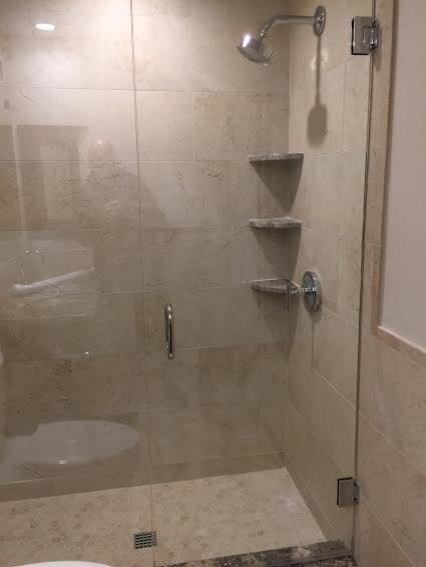Photo of a mid-sized modern 3/4 bathroom in Austin with flat-panel cabinets, dark wood cabinets, granite benchtops, an alcove shower, a two-piece toilet, beige tile, porcelain tile, beige walls and porcelain floors.