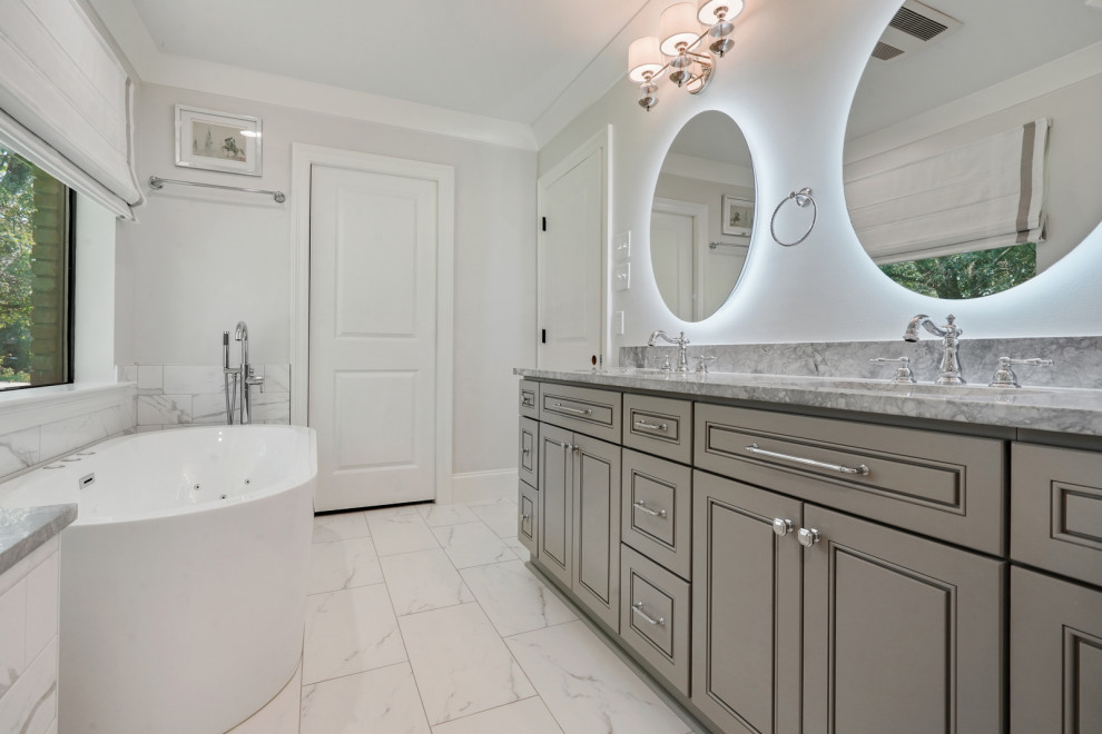 Large transitional master bathroom in New Orleans with flat-panel cabinets, grey cabinets, a freestanding tub, a double shower, white tile, marble, white walls, marble floors, an undermount sink, engineered quartz benchtops, white floor, a hinged shower door, grey benchtops, a shower seat, a single vanity and a built-in vanity.