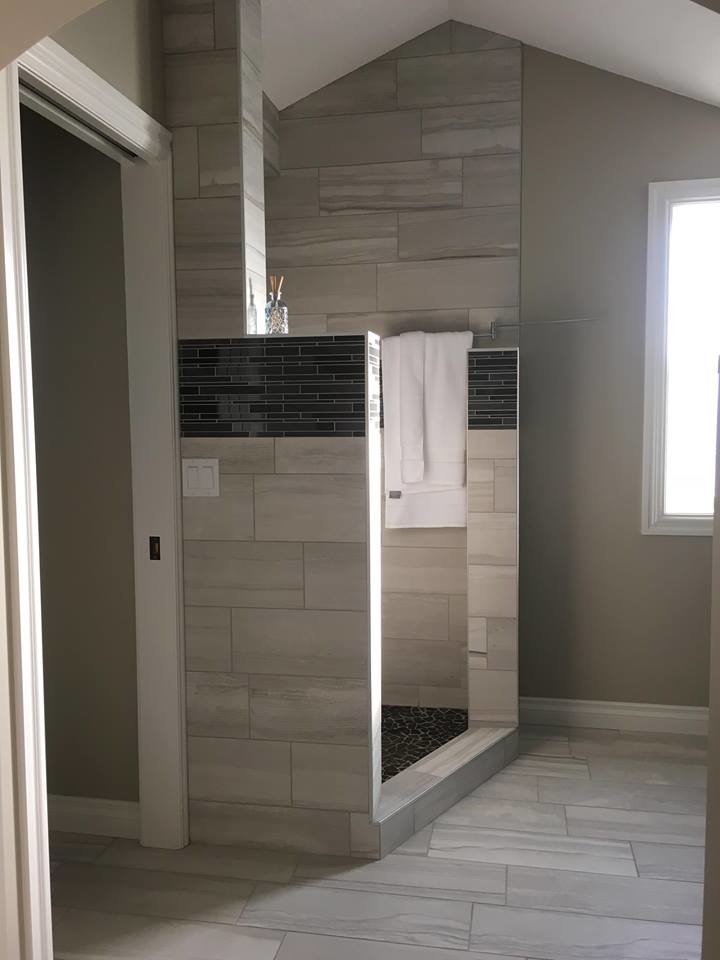 Inspiration for a mid-sized transitional master multicolored tile and matchstick tile vinyl floor alcove shower remodel with shaker cabinets, black cabinets, gray walls, an undermount sink and marble countertops
