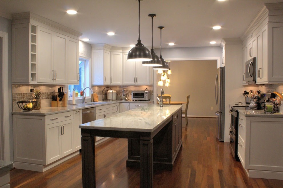 Eat-in kitchen - large transitional galley medium tone wood floor and brown floor eat-in kitchen idea in Baltimore with a single-bowl sink, recessed-panel cabinets, white cabinets, quartzite countertops, gray backsplash, glass tile backsplash, stainless steel appliances, an island and multicolored countertops