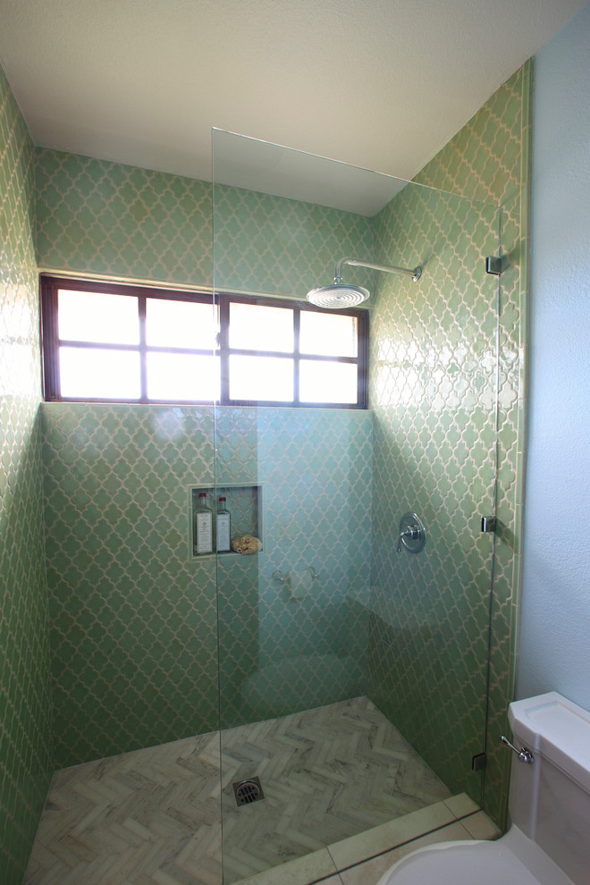 This is an example of a mid-sized modern 3/4 bathroom in New York with an undermount sink, recessed-panel cabinets, dark wood cabinets, a one-piece toilet, green tile, ceramic tile, blue walls and limestone floors.