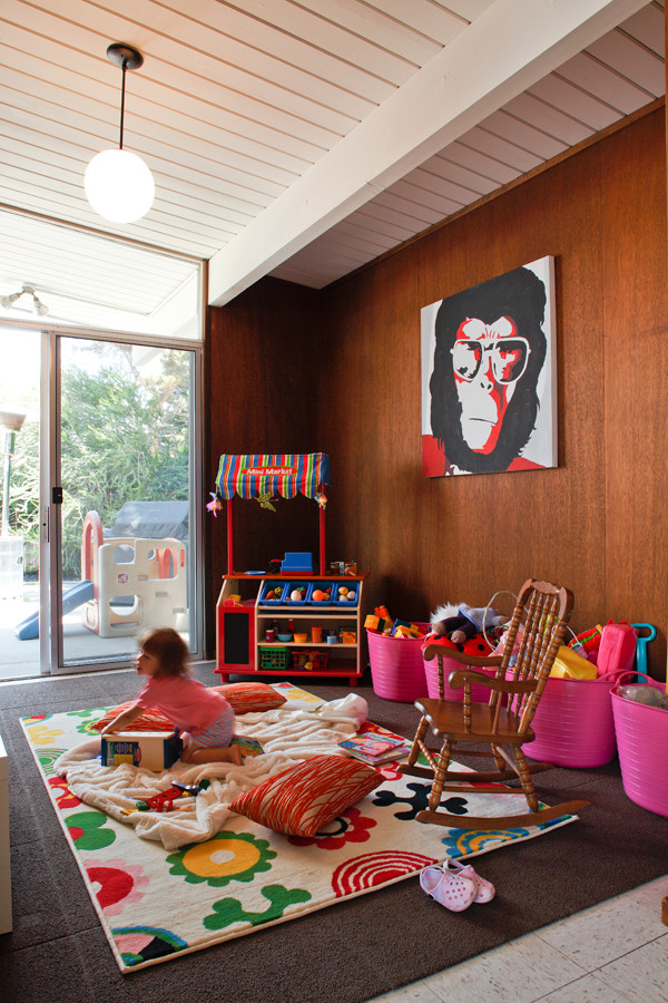 An Eichler For Every Age in Orange California - This Eichler home in Southern California shows that Eichler homes are perfect for active families. Access to outside adventures are just outside of the sliding doors in this playroom.  Floor-to-ceiling glass throughout the home make it easy for parents to keep kids within sight from many areas of an Eichler home. Contact us with any questions on what you see here. 
EichlerSoCal.com
