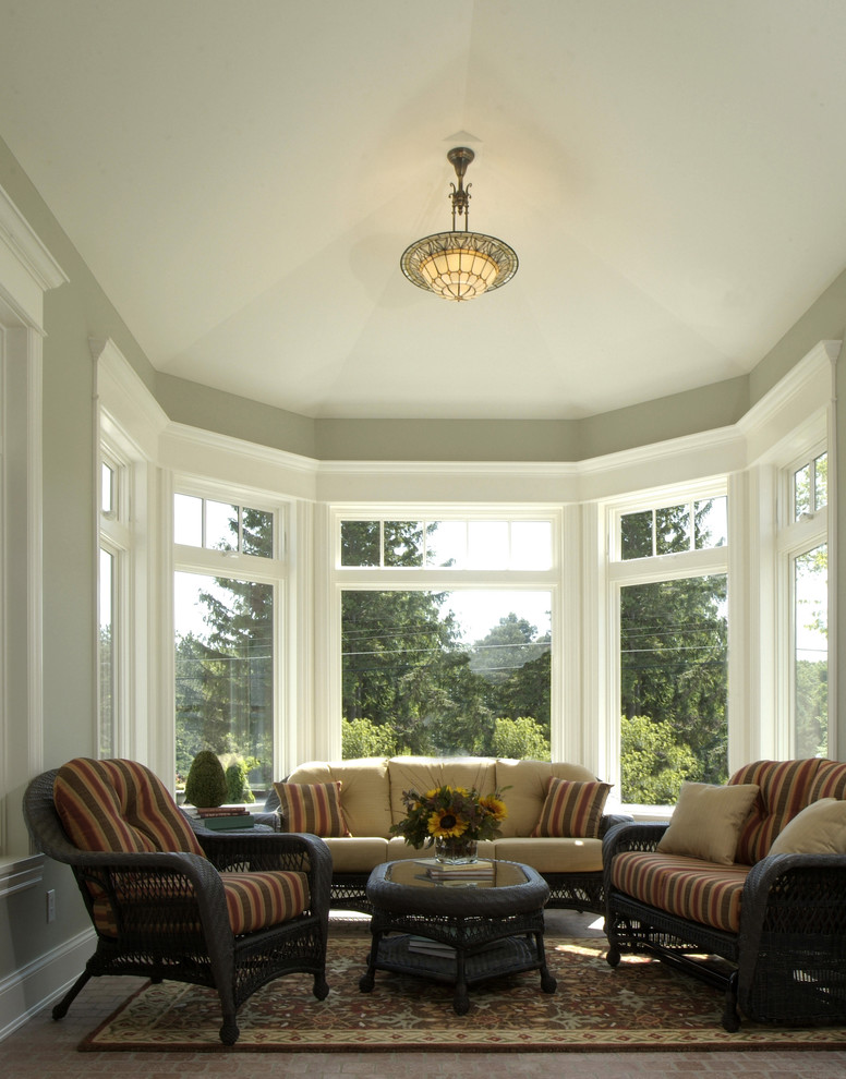 Photo of a large traditional sunroom in Grand Rapids with no fireplace, a standard ceiling and slate floors.