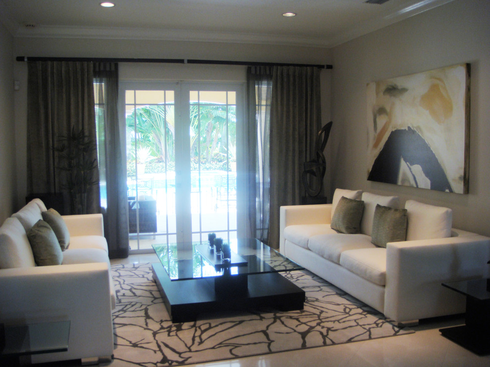Large contemporary formal open concept living room in Miami with beige walls and marble floors.