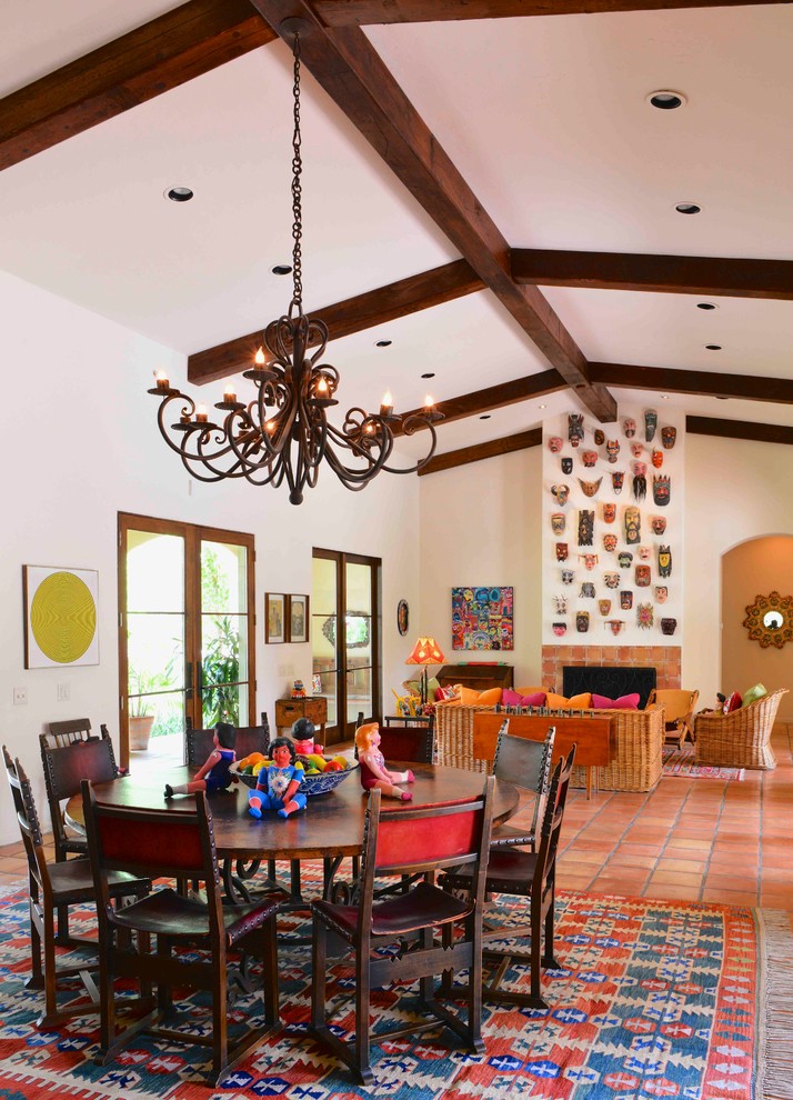 Large open plan dining in Houston with white walls, terra-cotta floors, a standard fireplace, a tile fireplace surround and red floor.