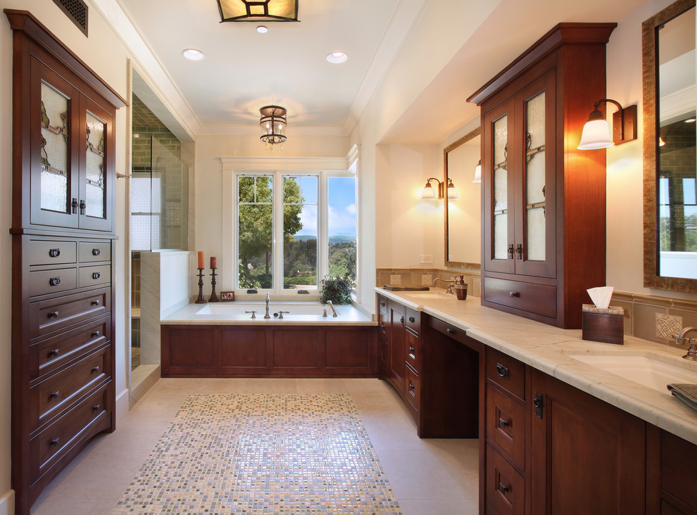 Photo of a large arts and crafts master bathroom in San Diego with an undermount sink, recessed-panel cabinets, dark wood cabinets, an alcove shower, beige tile, mosaic tile, beige walls, ceramic floors, an undermount tub, quartzite benchtops, beige floor and a hinged shower door.