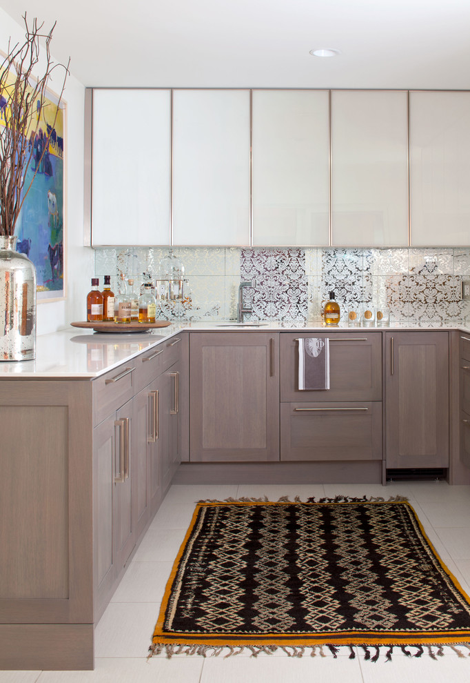 This is an example of a contemporary u-shaped wet bar in Denver with an undermount sink, flat-panel cabinets, white cabinets, multi-coloured splashback and mirror splashback.