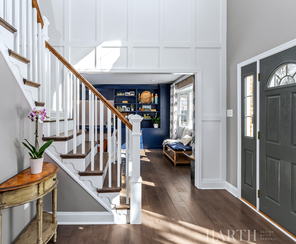 Design ideas for a mid-sized transitional foyer in Philadelphia with grey walls, dark hardwood floors, a single front door, a gray front door, brown floor and panelled walls.