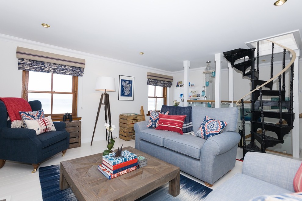 This is an example of a mid-sized beach style open concept living room in Other with white walls, painted wood floors, a wood stove and a wall-mounted tv.