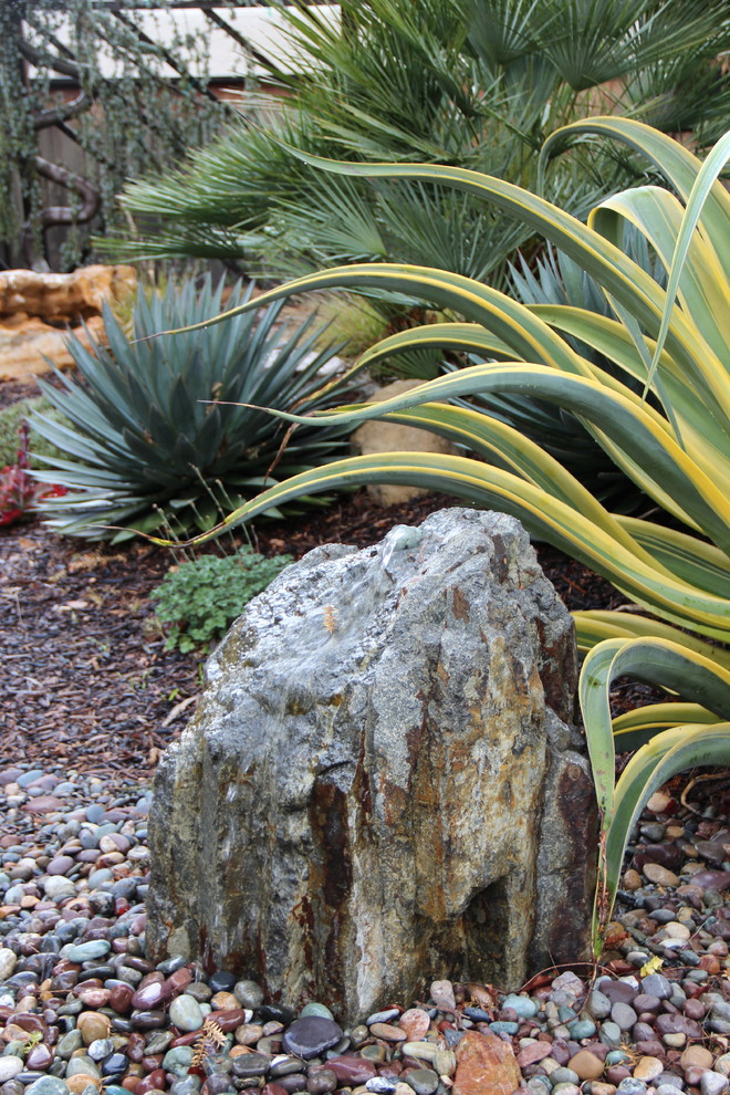 Inspiration for a mid-sized mediterranean backyard partial sun formal garden in San Luis Obispo with gravel.