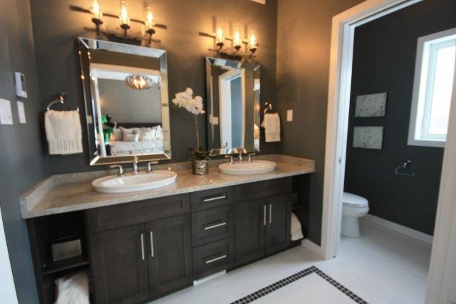 Photo of a traditional bathroom in Other with a drop-in sink, shaker cabinets, dark wood cabinets, granite benchtops, a two-piece toilet, white tile and porcelain tile.