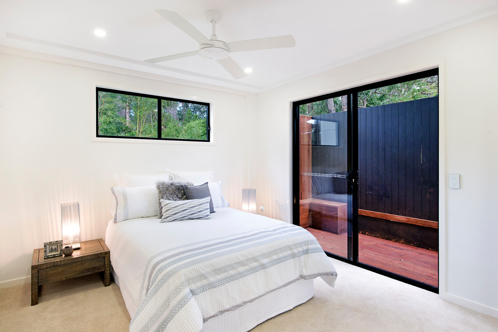 Photo of a contemporary bedroom in Brisbane with white walls, carpet and beige floor.