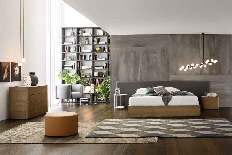 This is an example of a mid-sized contemporary loft-style bedroom in Berlin with grey walls, dark hardwood floors, brown floor, no fireplace and a concrete fireplace surround.