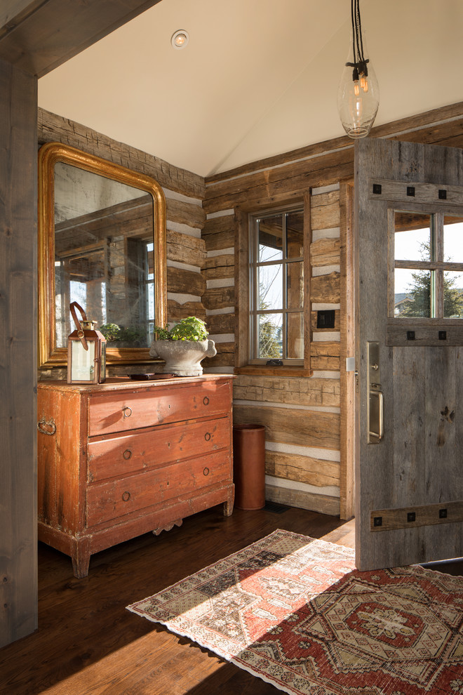 Example of a mountain style dark wood floor foyer design
