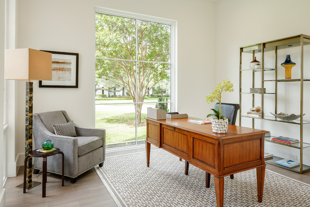 Photo of a transitional study room in Dallas with white walls, medium hardwood floors and a freestanding desk.