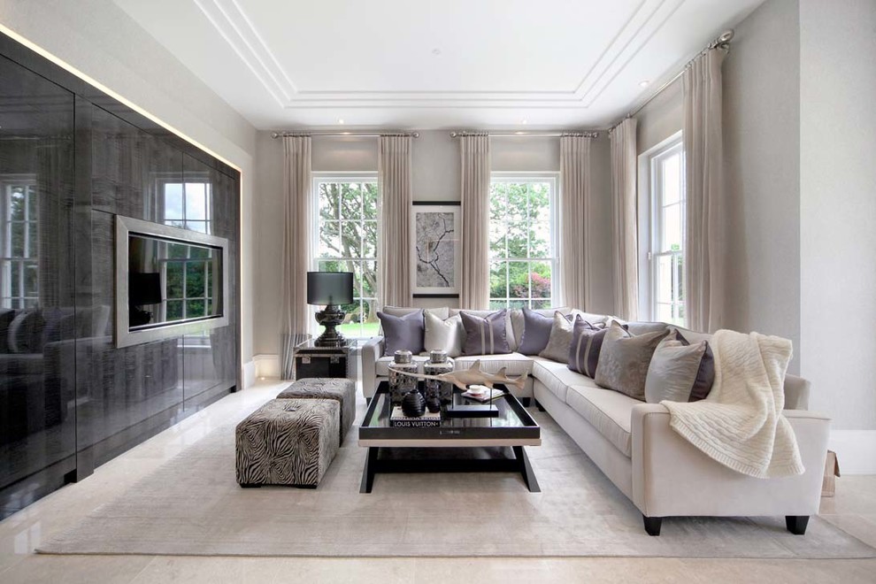 Mid-sized contemporary formal living room in Surrey with grey walls and a wall-mounted tv.