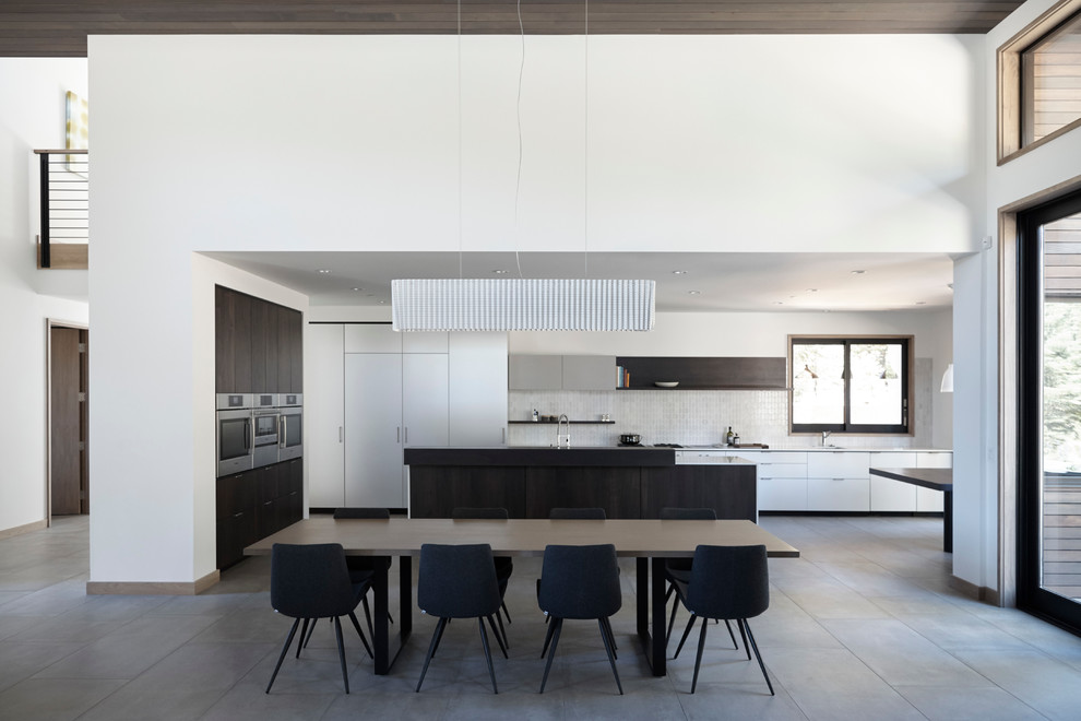 Inspiration for a large modern l-shaped porcelain tile open concept kitchen remodel in San Francisco with an undermount sink, flat-panel cabinets, white cabinets, quartz countertops, white backsplash, ceramic backsplash, paneled appliances and an island