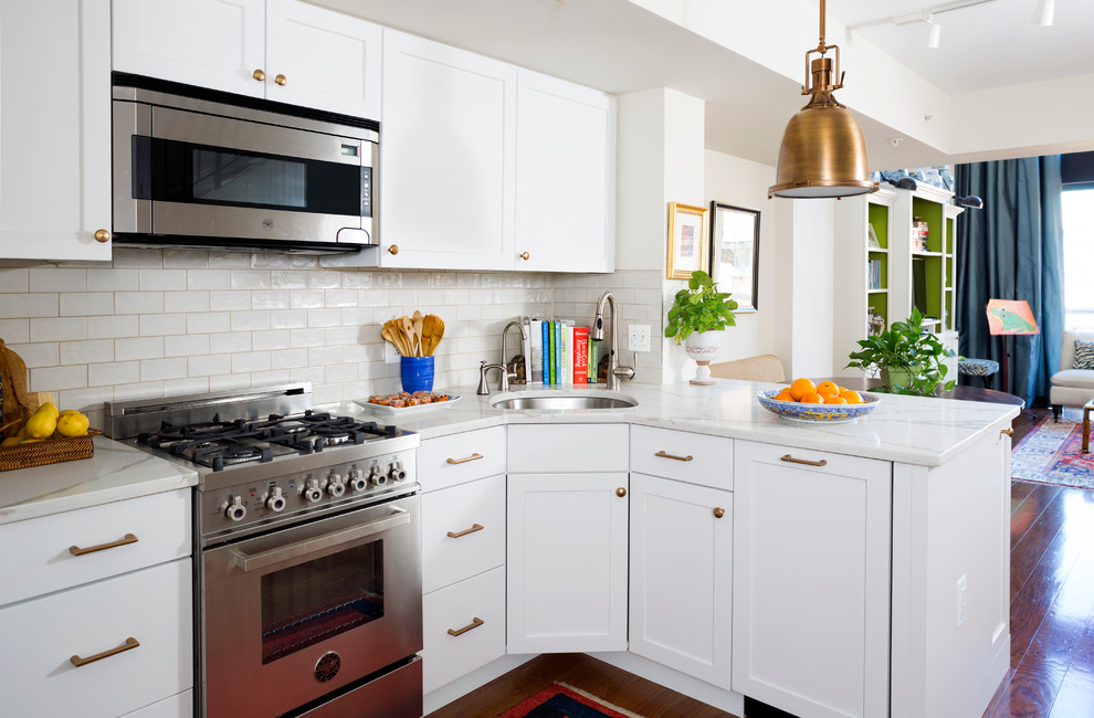 Inspiration for a small transitional single-wall kitchen in DC Metro with white cabinets, white splashback, subway tile splashback, stainless steel appliances and medium hardwood floors.