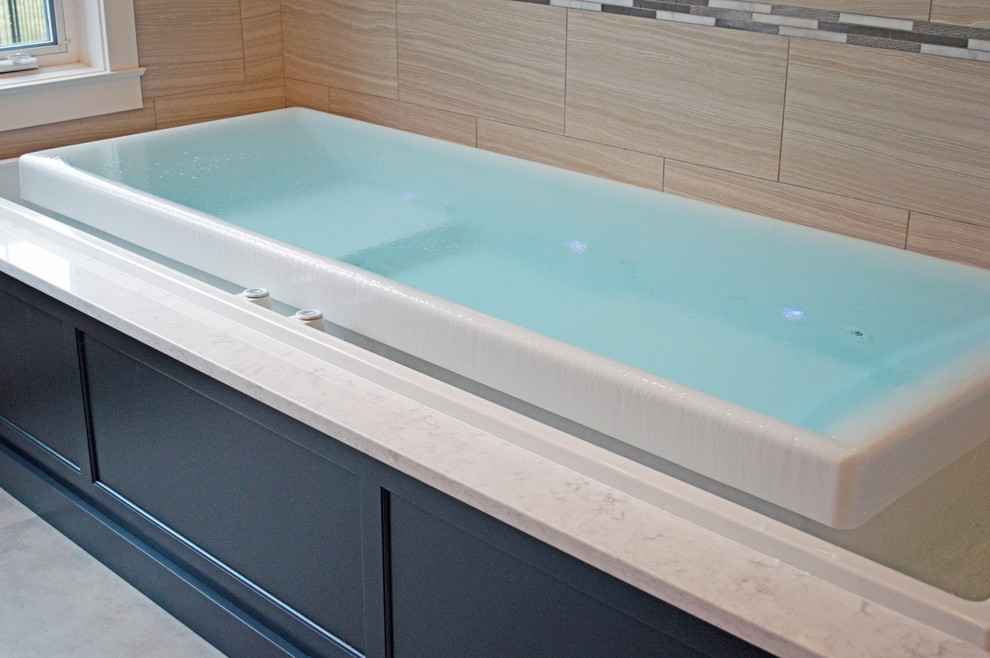Large transitional beige tile and porcelain tile porcelain tile sauna photo in Seattle with an undermount sink, shaker cabinets, gray cabinets, quartz countertops, an undermount tub, a bidet and gray walls