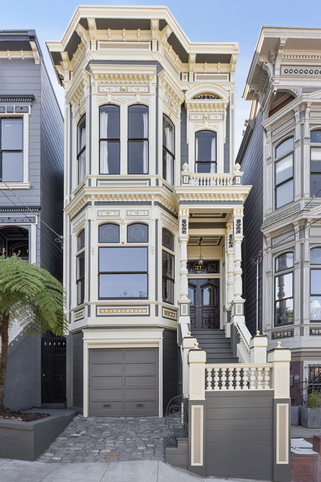 Photo of a large traditional two-storey beige house exterior in San Francisco with wood siding.