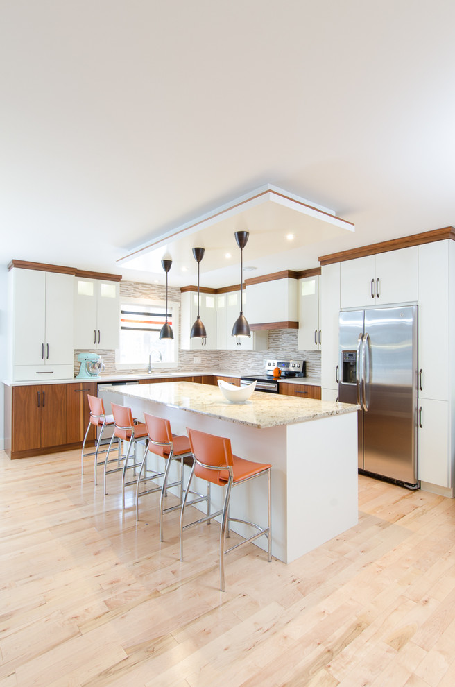 Eat-in kitchen - mid-sized transitional l-shaped light wood floor eat-in kitchen idea with an undermount sink, flat-panel cabinets, white cabinets, granite countertops, multicolored backsplash, mosaic tile backsplash, stainless steel appliances and an island