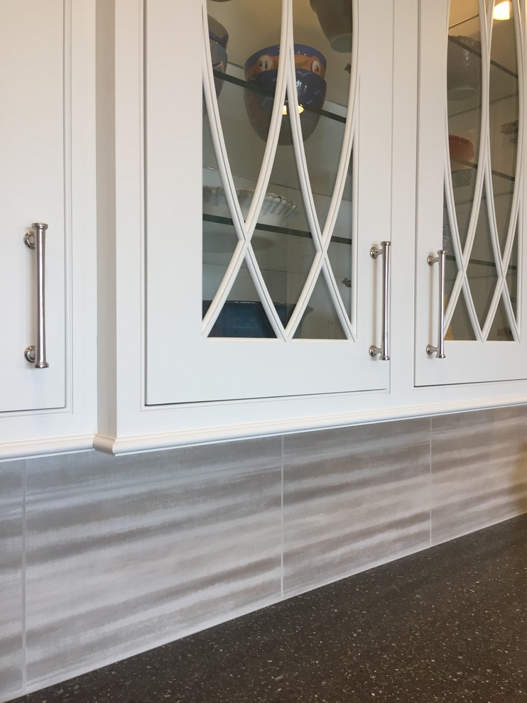Inspiration for a large transitional ceramic tile and multicolored floor kitchen remodel with a farmhouse sink, beaded inset cabinets, white cabinets, quartz countertops, metallic backsplash, ceramic backsplash, stainless steel appliances and an island