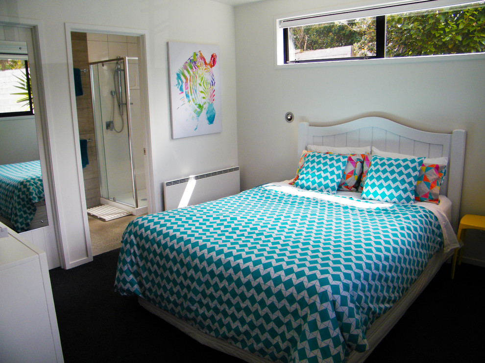 This is an example of a small beach style bedroom in Auckland.