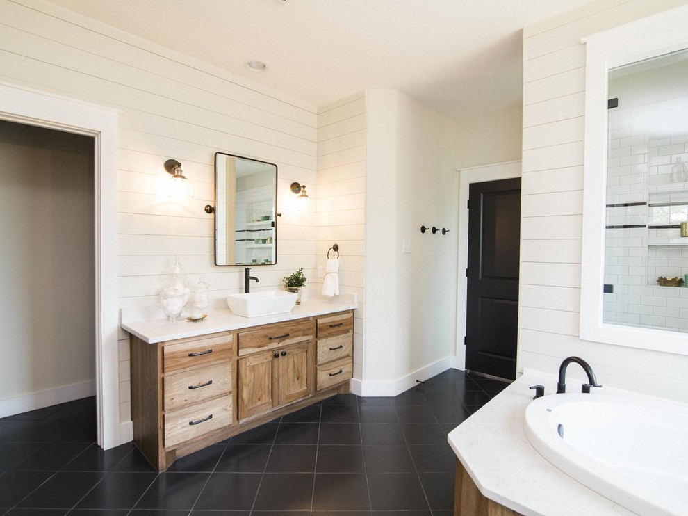Design ideas for a large country master bathroom in Austin with flat-panel cabinets, medium wood cabinets, a corner tub, white tile, ceramic tile, white walls, ceramic floors, black floor and white benchtops.