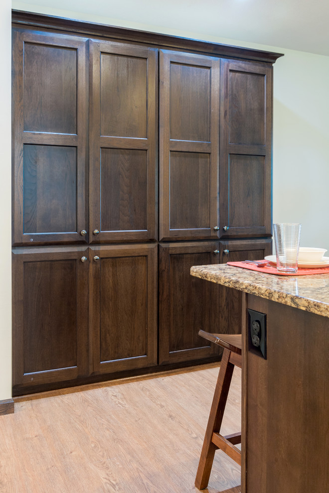 Inspiration for a mid-sized transitional l-shaped dark wood floor and brown floor eat-in kitchen remodel in Grand Rapids with an undermount sink, recessed-panel cabinets, dark wood cabinets, quartz countertops, beige backsplash, stainless steel appliances, a peninsula and beige countertops