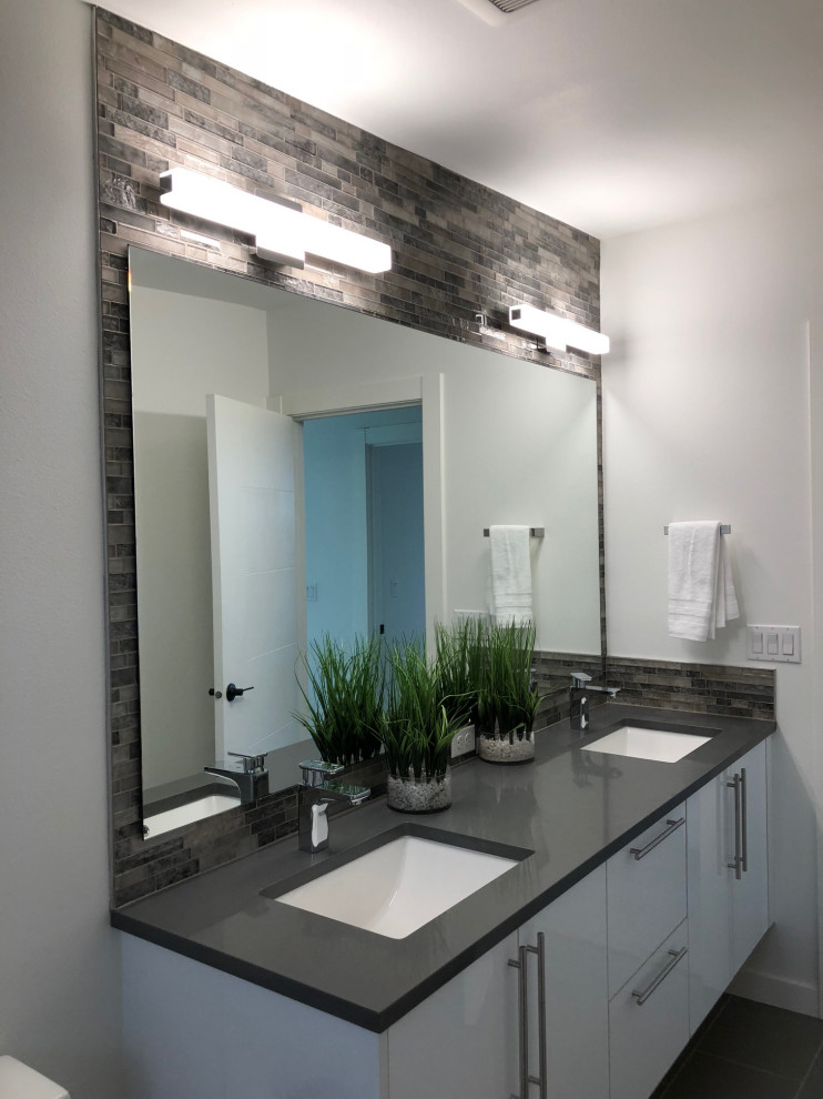 Mid-sized contemporary 3/4 bathroom in Other with flat-panel cabinets, white cabinets, brown tile, gray tile, matchstick tile, white walls, porcelain floors, an undermount sink, engineered quartz benchtops, grey floor and black benchtops.