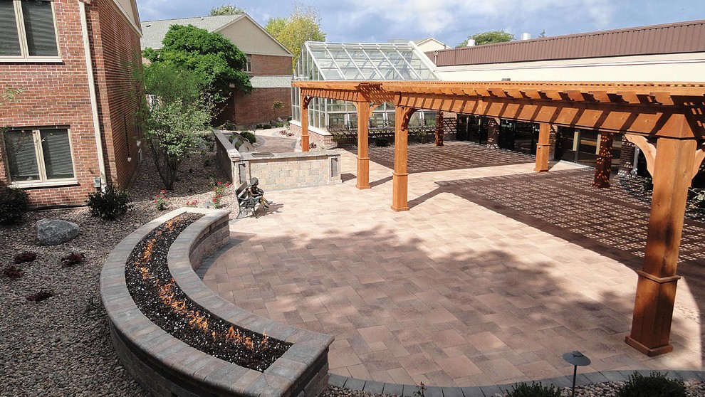 Inspiration for a large contemporary courtyard garden in Milwaukee with brick pavers.