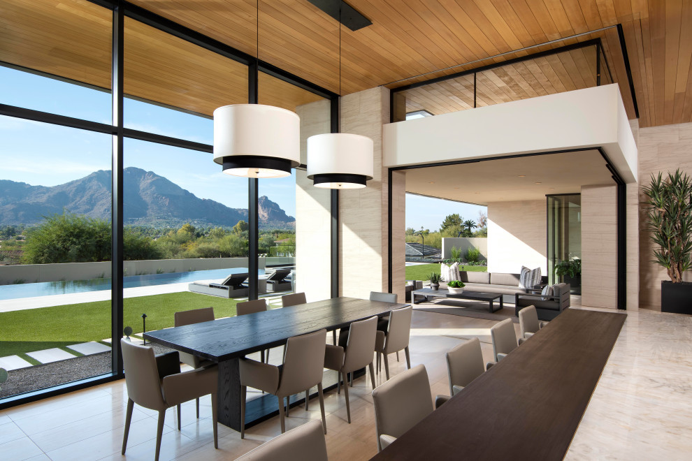 Expansive contemporary kitchen/dining room in Phoenix with limestone flooring and a wood ceiling.