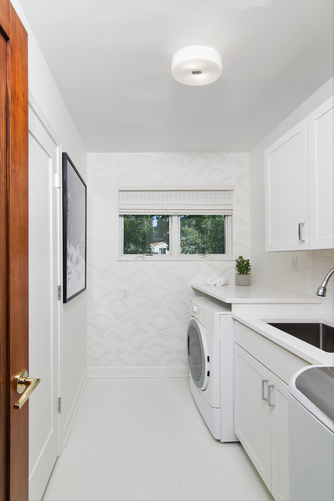 Design ideas for a mid-sized contemporary single-wall dedicated laundry room in Detroit with an undermount sink, shaker cabinets, white cabinets, quartz benchtops, white walls, linoleum floors, a side-by-side washer and dryer, white floor and white benchtop.