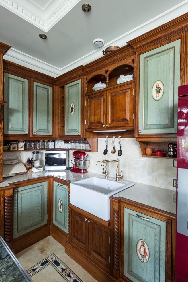 Mid-sized traditional u-shaped open plan kitchen in Moscow with a farmhouse sink, raised-panel cabinets, green cabinets, tile benchtops, beige splashback, ceramic splashback, ceramic floors, with island and beige floor.