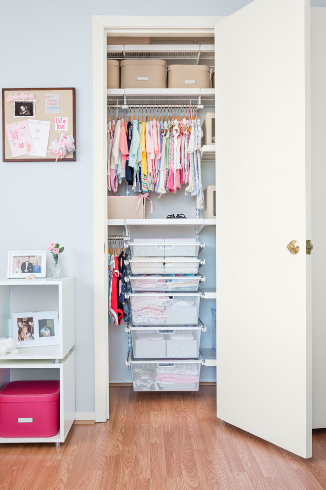 Traditional nursery in Other with grey walls and light hardwood floors for girls.