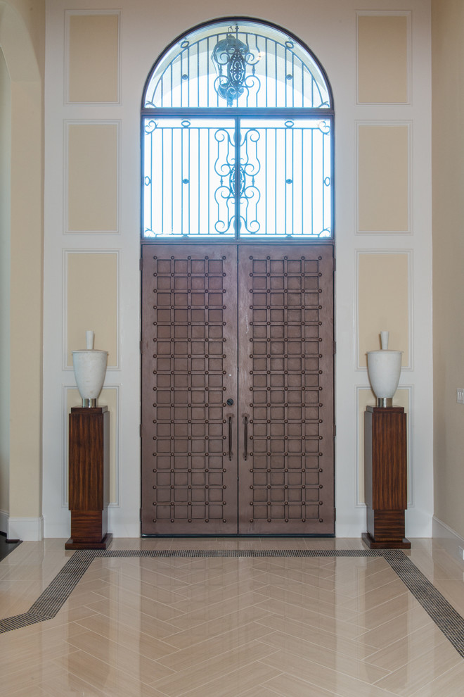 Example of a large transitional porcelain tile and beige floor front door design with beige walls and a brown front door