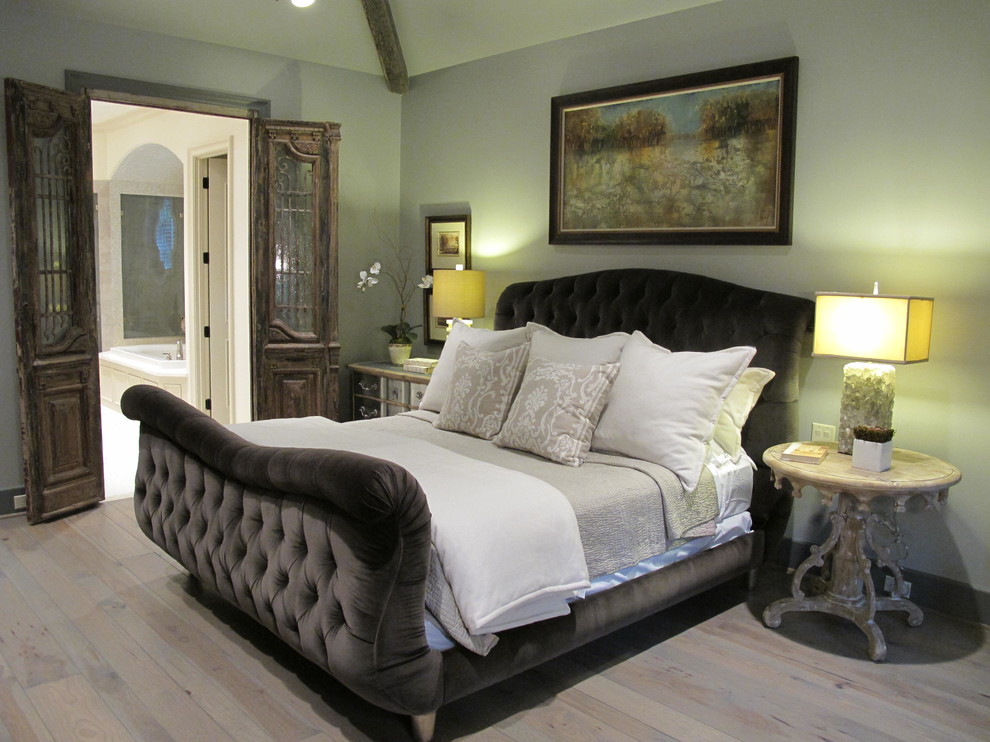Contemporary bedroom in Houston with grey walls and light hardwood flooring.