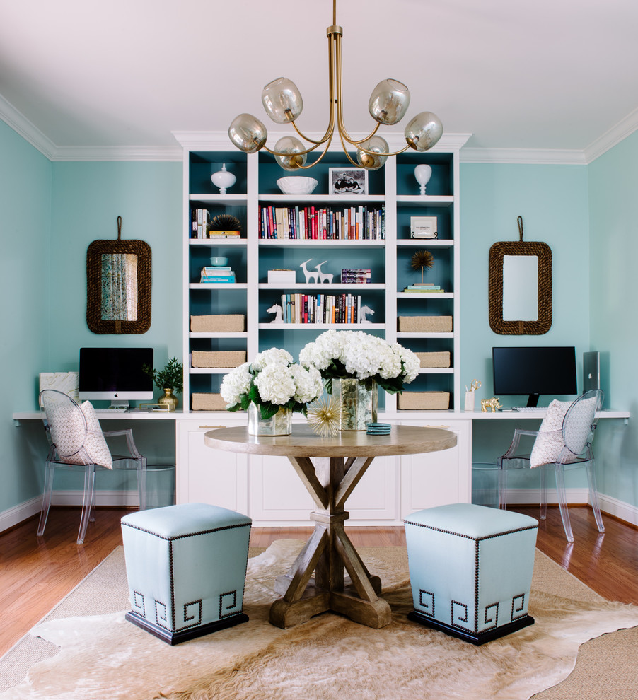 Study room - transitional built-in desk medium tone wood floor study room idea in DC Metro with blue walls