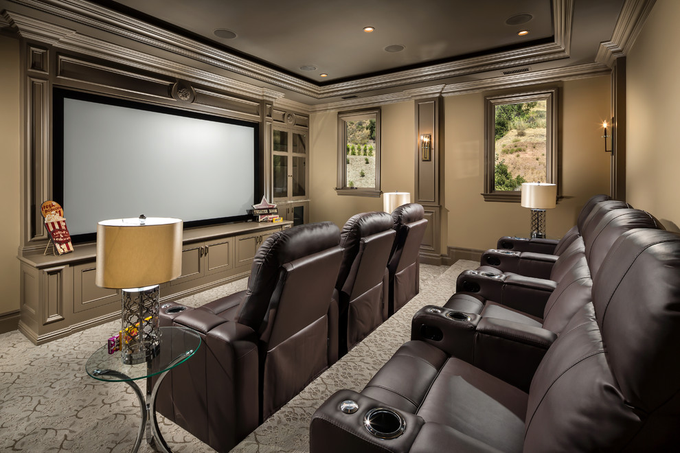 Mediterranean enclosed home theatre in Orange County with brown walls, carpet, a projector screen and multi-coloured floor.