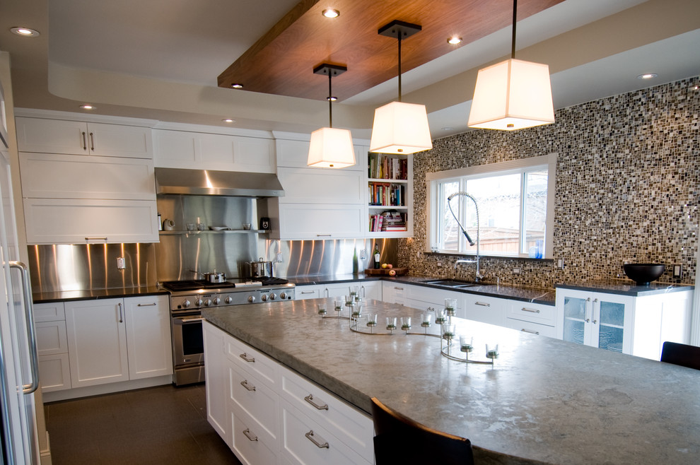 Inspiration for a large transitional u-shaped porcelain tile open concept kitchen remodel in Denver with an undermount sink, shaker cabinets, white cabinets, concrete countertops, multicolored backsplash, mosaic tile backsplash, stainless steel appliances and an island