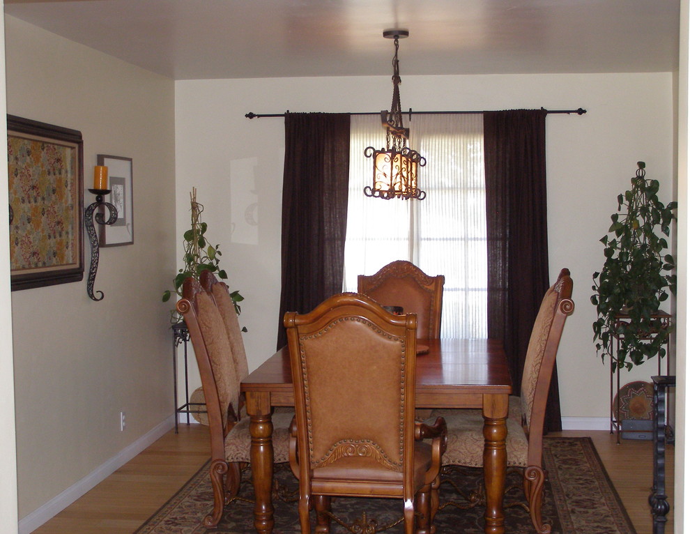 Photo of a mid-sized mediterranean separate dining room in Los Angeles with white walls and light hardwood floors.