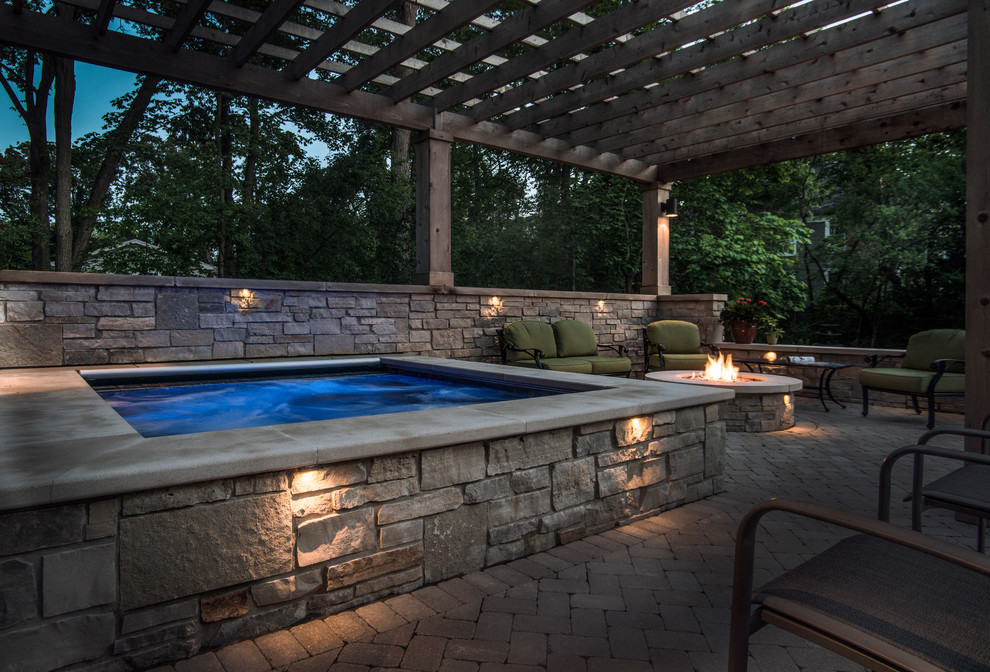 Inspiration for a small traditional backyard rectangular pool in Chicago with a hot tub and concrete pavers.
