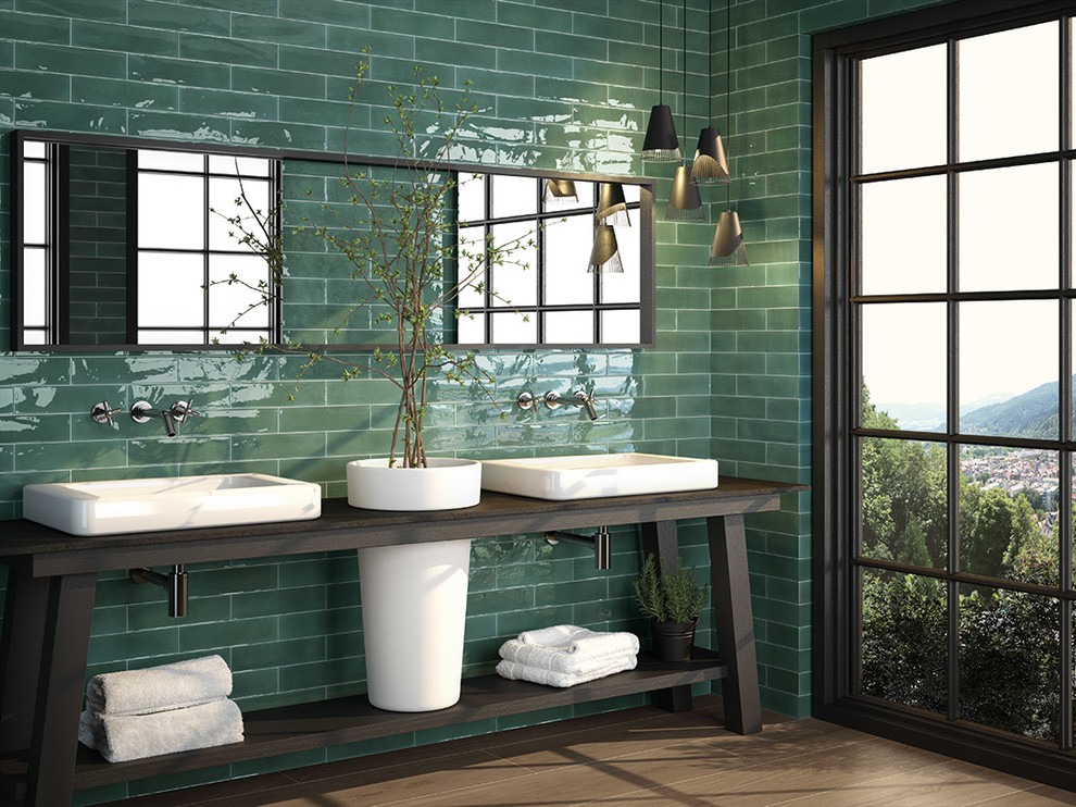 Photo of a midcentury bathroom in Other with subway tile, green walls, medium hardwood floors, a vessel sink, wood benchtops and brown floor.