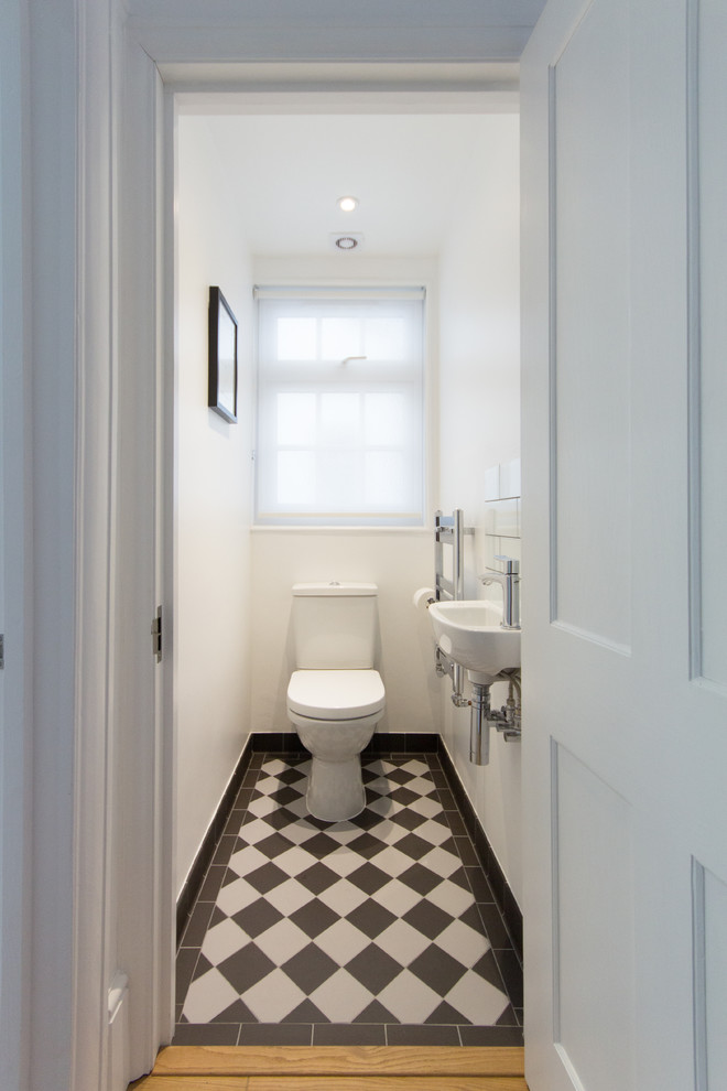 Design ideas for a small contemporary powder room in London with black and white tile, white walls, porcelain floors, a wall-mount sink and a two-piece toilet.