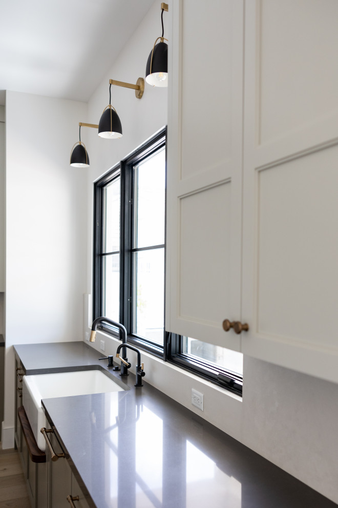 Open concept kitchen - large transitional galley open concept kitchen idea in Phoenix with an integrated sink, recessed-panel cabinets, gray cabinets, marble countertops, white backsplash, marble backsplash, paneled appliances, an island and white countertops