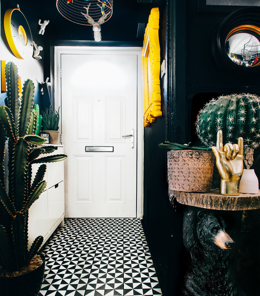 Example of a small eclectic ceramic tile hallway design with black walls