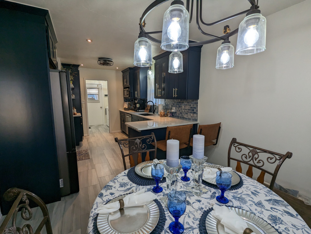 Example of a mid-sized transitional l-shaped eat-in kitchen design in Oklahoma City with shaker cabinets, blue cabinets, quartz countertops and blue backsplash