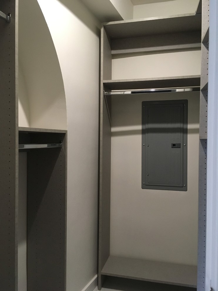Design ideas for a small modern gender-neutral walk-in wardrobe in Chicago with flat-panel cabinets, grey cabinets, ceramic floors and grey floor.
